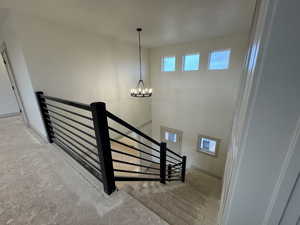 Staircase with an inviting chandelier