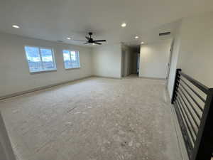 Unfurnished living room with ceiling fan