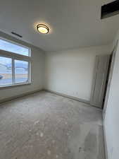 Spare room featuring a textured ceiling