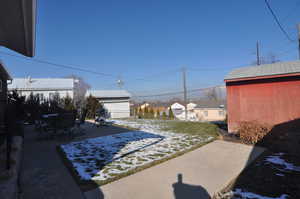 View of yard featuring a shed and a patio