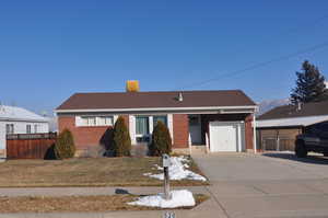 View of front facade with a front lawn and a garage