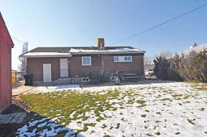 Rear view of house featuring a yard and a patio