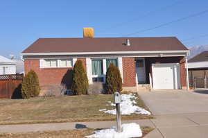 View of front of house featuring a garage and a front yard