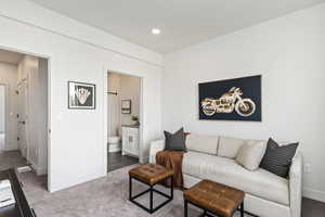 Living room with carpet flooring. This is the model home.