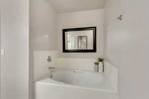 Primary Bathroom featuring a jetted bathtub