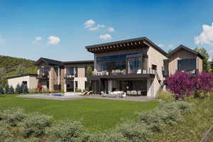 Back of house with a balcony, an outdoor living space, a patio area, and a yard