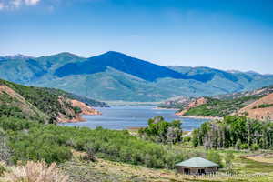 Property view of mountains featuring a water view