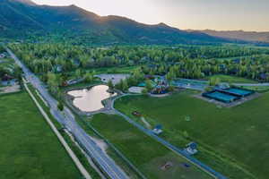 Aerial view at dusk featuring a water and mountain view