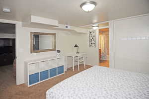 Bedroom with ensuite bathroom and carpet flooring