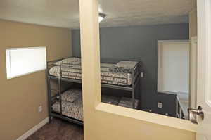 Carpeted bedroom with a textured ceiling