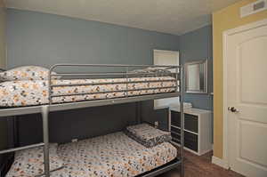 Bedroom featuring a textured ceiling and carpet flooring