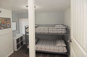 Carpeted bedroom with a textured ceiling