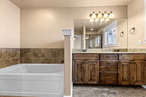 Bathroom featuring independent shower and bath and vanity