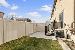 View of yard featuring central air condition unit and a patio area