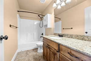 Full bathroom featuring toilet, shower / tub combination, and vanity