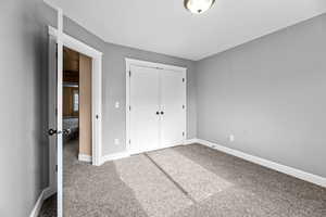 Unfurnished bedroom with carpet and a closet