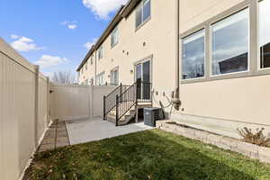 View of yard featuring cooling unit and a patio