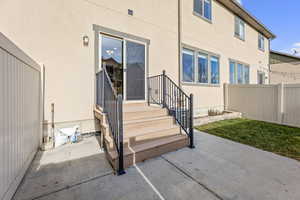 View of exterior entry with a patio area