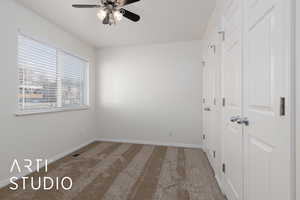 Unfurnished bedroom with ceiling fan, a closet, and carpet