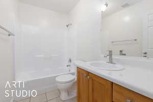 Full bathroom featuring toilet, tile patterned flooring, shower / bathtub combination, and vanity