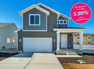 View of front of home featuring an attached garage, stucco siding, board and batten siding, and concrete driveway