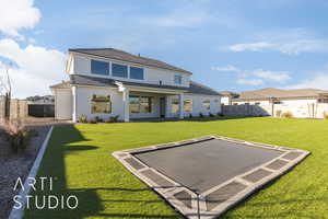 Rear view of house featuring a yard