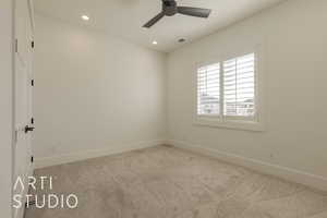 Carpeted spare room with ceiling fan