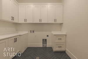 Washroom with washer hookup, cabinets, and hookup for an electric dryer