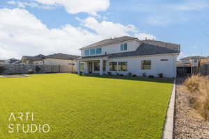 Back of property featuring a lawn