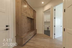 Mudroom with light hardwood / wood-style flooring