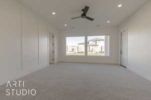 Unfurnished room with ceiling fan and light carpet