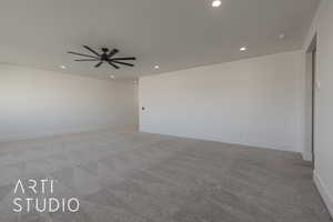 Carpeted empty room featuring ceiling fan