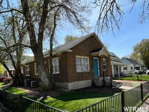 Bungalow-style home with a front lawn