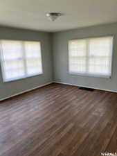 Unfurnished room featuring dark hardwood / wood-style flooring