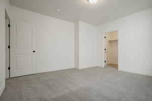 Unfurnished room featuring light carpet