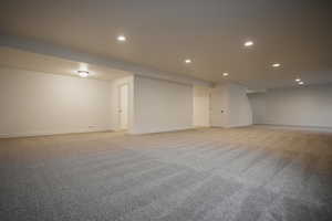 Basement featuring light carpet