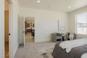 Bedroom featuring light carpet, recessed lighting, and baseboards