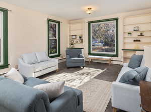 Carpeted living room featuring a baseboard radiator