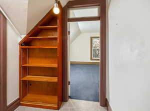 Stairs featuring carpet floors and lofted ceiling