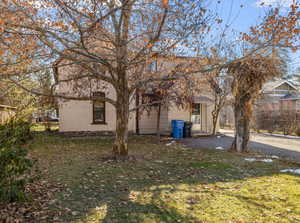 Rear view of property featuring a lawn