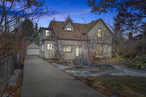 View of front facade featuring a garage and an outdoor structure