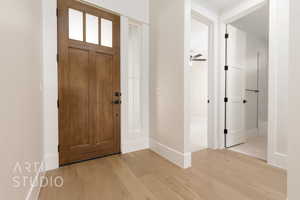 Entryway with ceiling fan and light hardwood / wood-style flooring