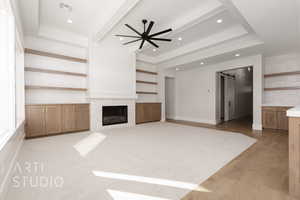 Unfurnished living room with ceiling fan, light hardwood / wood-style floors, and a barn door