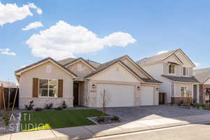 View of front of property featuring a garage and a front lawn