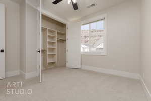 Unfurnished bedroom with light carpet, ceiling fan, and a closet