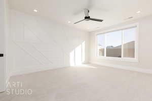 Carpeted empty room featuring ceiling fan