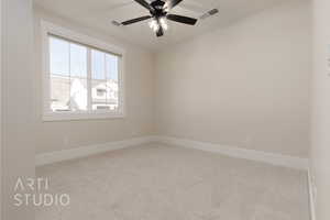 Unfurnished room with ceiling fan and light colored carpet