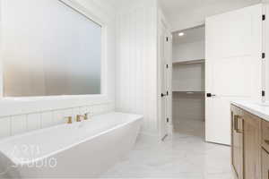 Bathroom featuring a bath and vanity