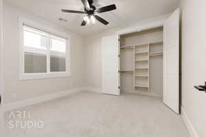 Unfurnished bedroom featuring light carpet, ceiling fan, and a closet