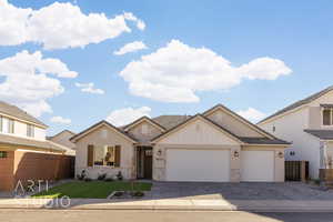 View of front of property with a front yard and a garage